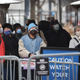 Residents wait in line to be vaccinated at a mass COVID-19 vaccination center set up in a parking lot outside of the United Center, home to the Chicago Bulls and Blackhawks, on March 10, 2021 in Chicago, Illinois.